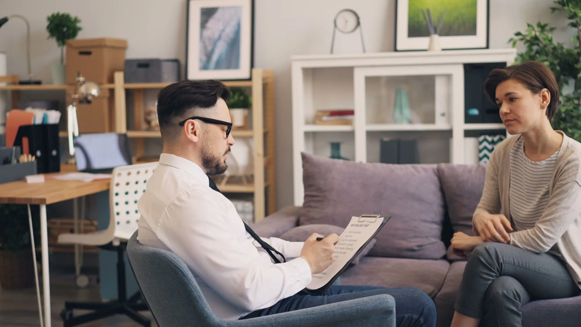 A mental health professional in conversation during a consultation